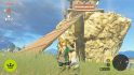 The Legend of Zelda Tears of the Kingdom review: Link looking directly ahead. A large wooden plank bridge is behind him, leading up to a tower.