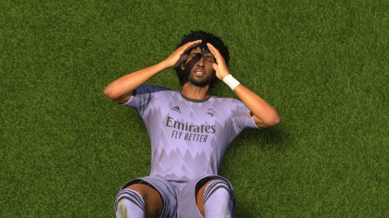 EA FC 23 claim all: A player in a Real Madrid shirt lies on the pitch with his head in his hands after losing a game in FIFA 23