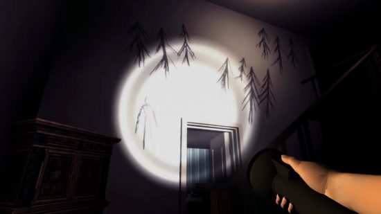 Xbox Games with Gold August 2023 free games: Someone holding a flashlight up at a wall with Slender Man drawings in Slender The Arrival