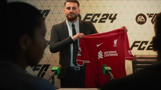FC 24 Player Career: A man in a suit at a press conference holds up a red Liverpool shirt