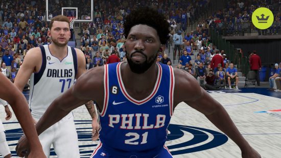 NBA 2K24 Embiid rating: Joel Embiid in a blue basketball jersey with his arms outstretched