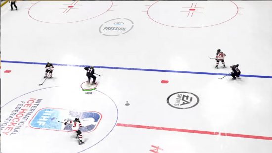 NHL 24 release date: A player passing the puck to another player.