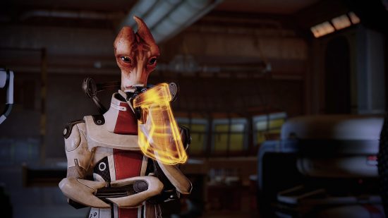 Best space games: An alien creature wearing a red and white spacesuit with a glowing golden device around its wrist in Mass Effect Legendary Edition.