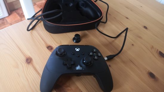 PowerA Fusion Pro 3 Wired Xbox controller. Image shows a controller besides its box, near its cable and swappable thumbstick.