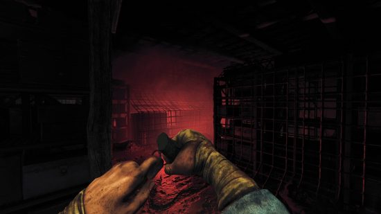 Best Xbox horror games: The character from Amnesia: The Bunker getting ready to throw a grenade in a dark hallway.