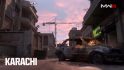 MW3 maps: A car on fire in a street in the remastered Karachi map.