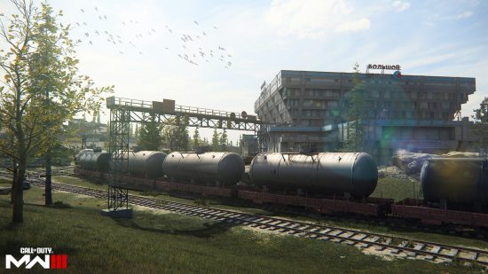 Call of Duty MW3 maps: A train track cutting through a wooded area, with a large building in the background as part of the Levin Resort map.