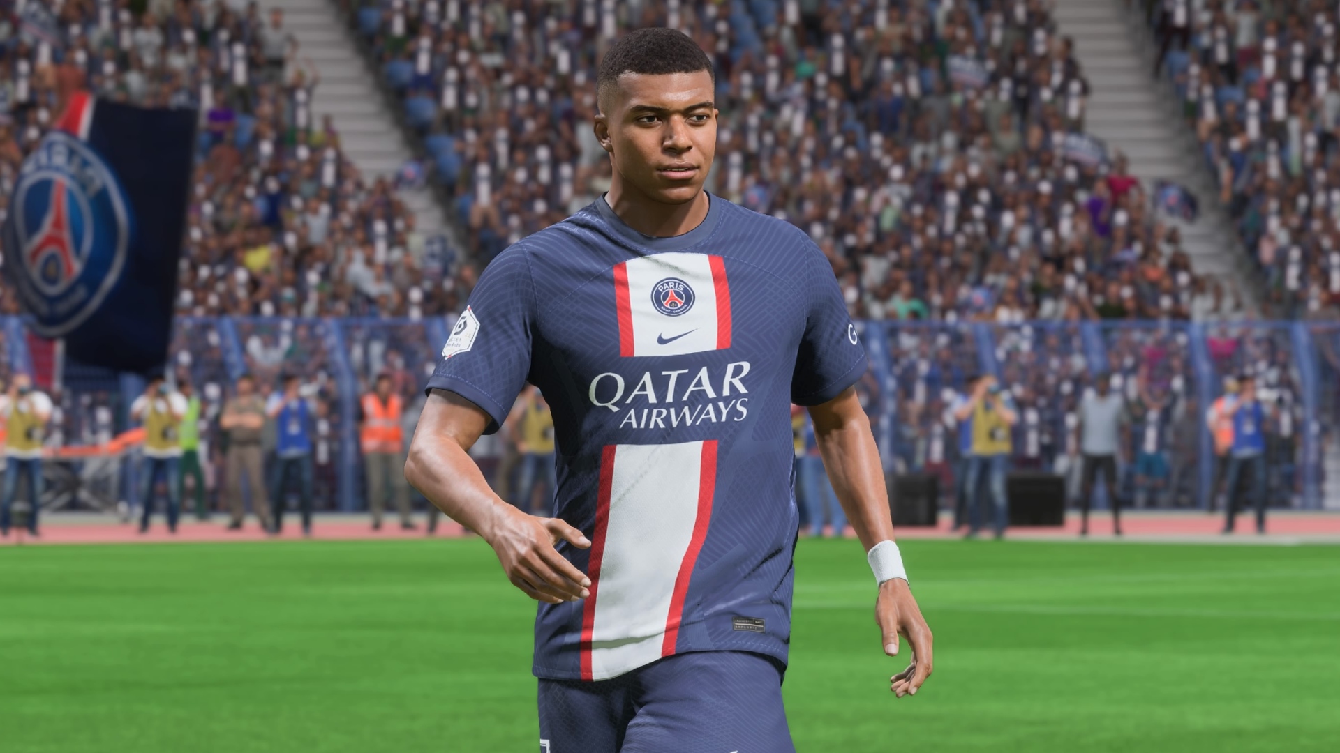 EA FC 24: Kylian Mbappe in a blue white and red PSG kit walking across a pitch