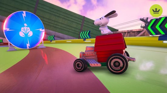 Hot Wheels Unleashed 2 review: A red car with Snoopy sat on the top slides around a corner, facing a large blue target