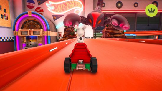 Hot Wheels Unleashed 2 review: A red toy car on a red plastic track with a jukebox and neon Hot Wheels sign in the background