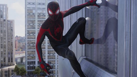 Spider-Man 2 PS5 review: Miles Morales hanging off the side of a building in Spider-Man 2.