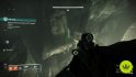 Destiny 2 The Coil: The player looking into a small crevice in a rock wall where a hidden chest can be found in The Coil.
