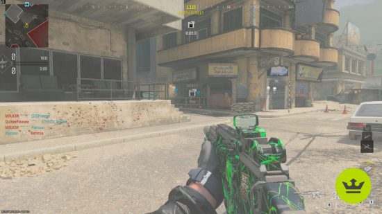 MW3 meta: A player holding the Holger 556 at the ready in a sandy, urban environment, painted with a green and black camo.
