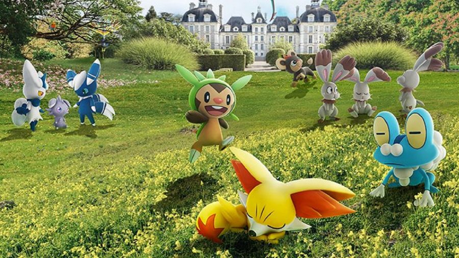 Pokémon GO: a trio of Pokémon playing on a lush green, surrounded by townhouses