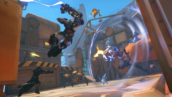 Best multiplayer games: Various characters fighting in an industrial style environment in Overwatch 2.