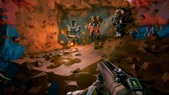 Xbox Game Pass Core games: A first-person view of someone holding a shotgun while exploring a cave. Three other players wearing heavily-armored suits are seen heading into a small entrance
