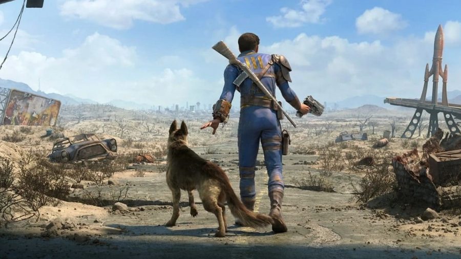 Fallout news: A man in a blue jumpsuit with a rifle strapped to his back walking through a wasteland with a dog by his side
