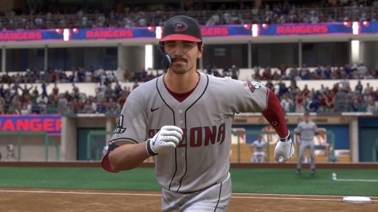 Best sports games: A baseball player in a white jersey running to a base