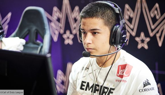 Dallas Empire player Shotzzy looking at a monitor, wearing a white jersey and headset