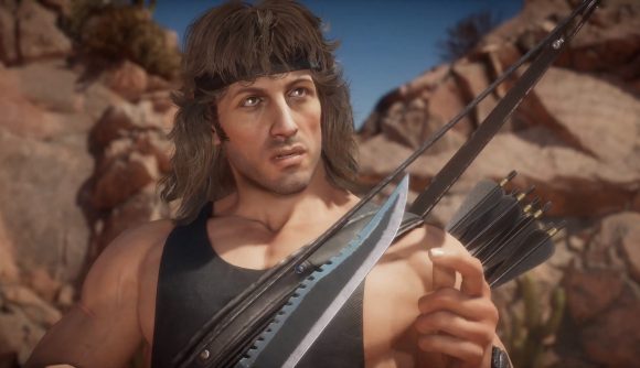 Rambo holding a serrated dagger. He has a bow and some arrows strapped to his back.