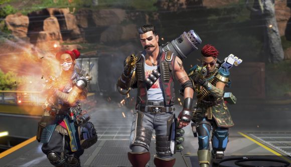 Apex Legends' newest character Fuse walks towards the camera, flanked by Lifeline, who is firing her weapon, and Rampart.