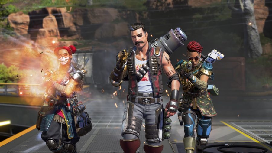 Apex Legends' newest character Fuse walks towards the camera, flanked by Lifeline, who is firing her weapon, and Rampart.