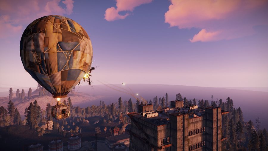 A patchwork hot air balloon being fired at with missiles from a tall, beige building
