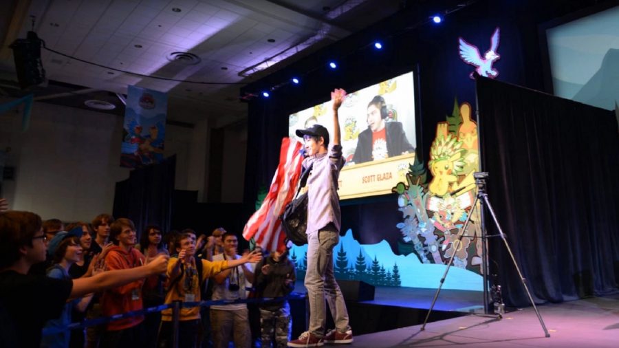 Aaron 'Cybertron' Zheng celebrates on stage after coming third in the 2013 World Championships. He holds an American flag