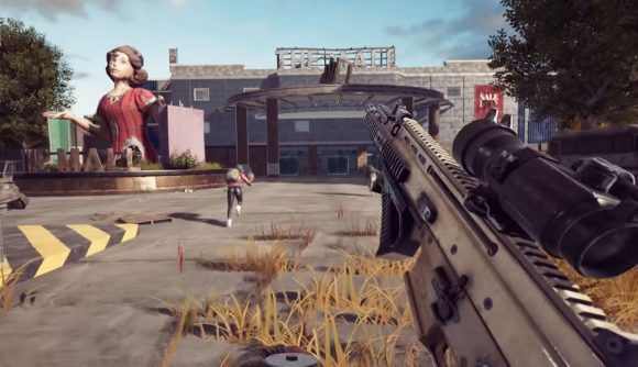 A dilapidated mall viewed from the first-person perspective of someone reloading an assault rifle. A large statue of a shrugging woman is on the left.