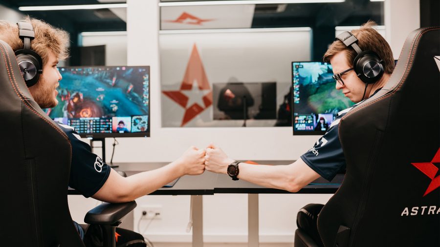 Astralis' Zanzarah and Whiteknight fist bumping in their gaming chairs