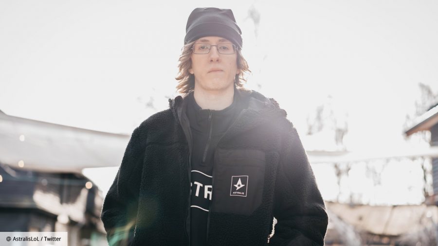 A young man with long hair and glasses, wearing a beanie and a black jacket