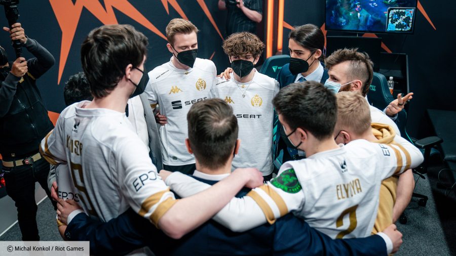The MAD Lions League of Legends team huddled in their white and gold jerseys