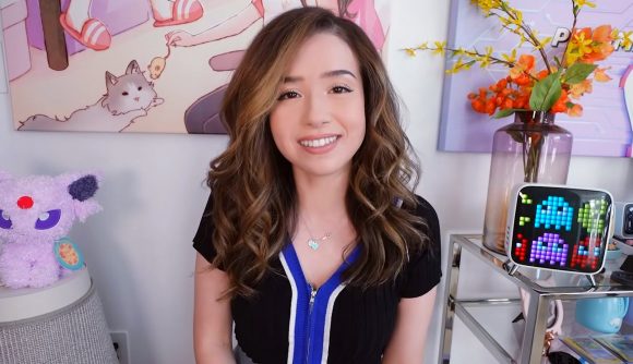Twitch streamer Pokimane looking down the camera, wearing a black and blue top