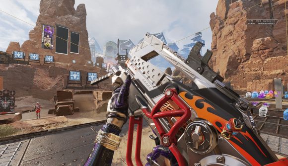 The L-Star LMG, with hot rod flames painted on it, being inspected in Apex Legends
