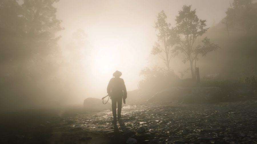 A cowboy gripping a ridle in his left hand walks into the fog