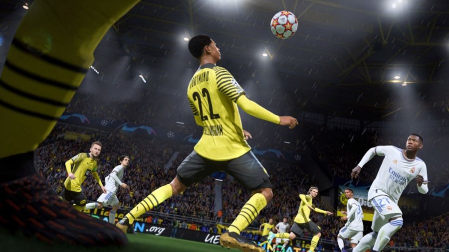 FIFA 22 screenshot of Dortmund's Jude Bellingham, wearing a yellow and black kit, controlling a football with his chest
