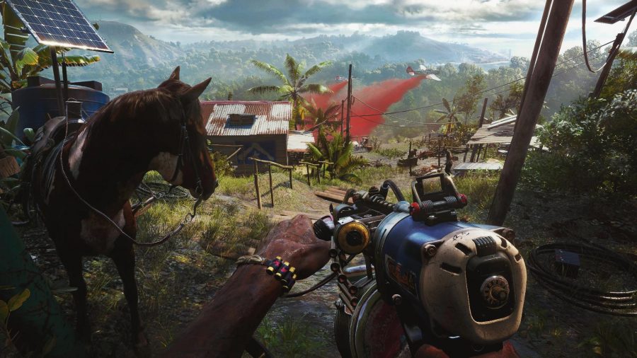 Far Cry 6 Review: Dani stands overlooking a hillside with a weapon in hand, a building in front of them and a horse on their left. 