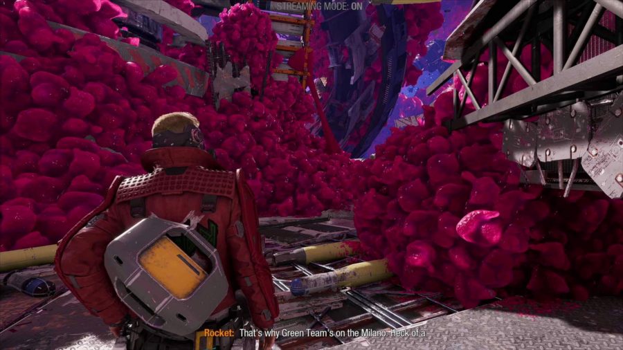 Guardians Of The Galaxy Streamer Mode: Star-Lord can be seen standing in front of some pink structures in the Quarantine Zone with the Streamer Mode text along the top of the screen.