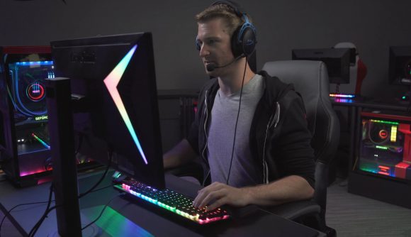 A man wearing the HyperX Cloud Alpha S headset at a gaming setup