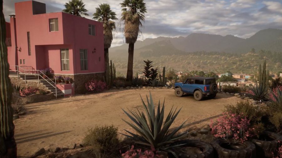 Forza Horizon 5 Player Houses: A car can be seen driving up to a player house in the desert