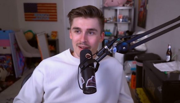 YouTube streamer Ludwig, sitting in front of his streaming microphone, wearing a white jumper