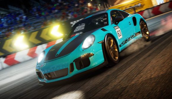 Grid Legends Microtransactions: A blue painted vehicle can be seen driving in the night on a track.