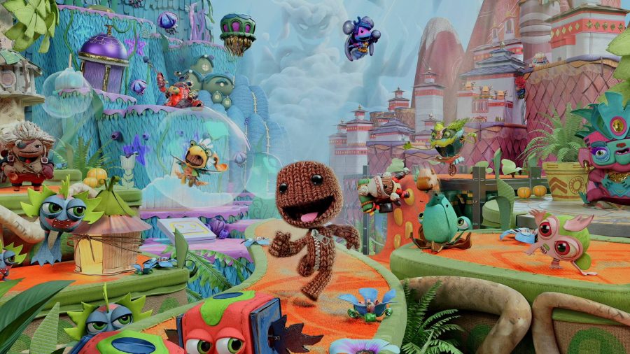PS5 PS4 Game Pass competitor launch games: Sackboy is running through the world with creatures and stickers floating around him.