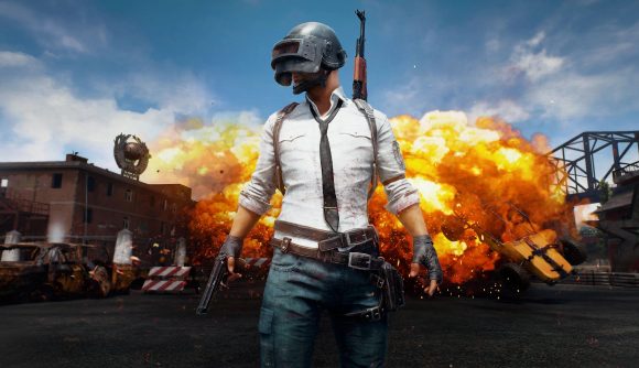 PUBG free-to-play: The iconic PUBG soldier with a white shirt and helmet walking away from an explosion