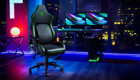 A lifestyle shot of the Razer Iskur gaming chair with a PC and two monitors in the background