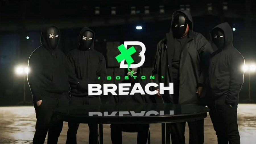 The roster of Boston Breach stand around a table wearing all black tracksuits and black face coverings
