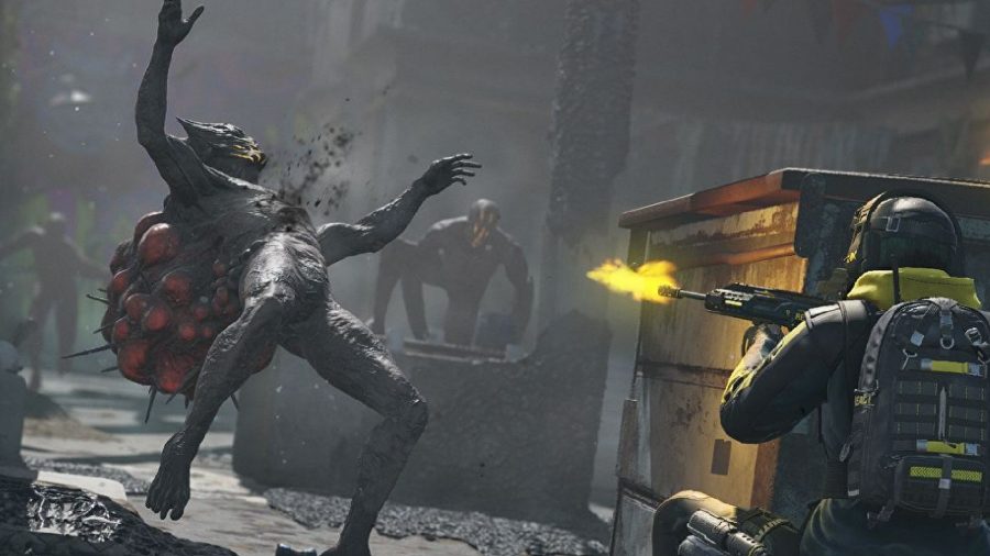Rainbow Six Extraction review: An operator can be seen shooting Archaeans from behind a dumpster.