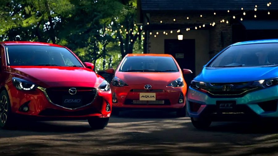 Gran Turismo 7 Best Starter Cars: Three cars, a red Mazda, an orange Toyota, and a blue Honda, in a courtyard