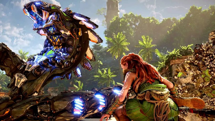 Horizon Forbidden West Valor Surges: Aloy crouched hiding from a giant snake machine