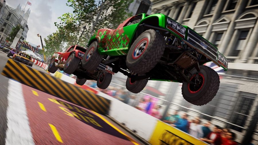 GRID Legends review: Two racing trucks get some air after driving over a ramp